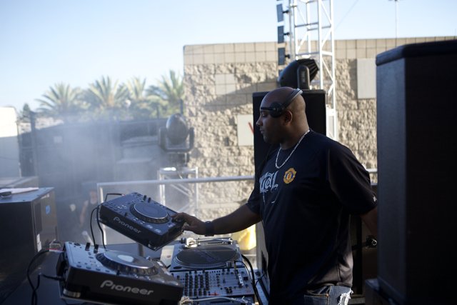 DJ mixes the beat under the sunny skies
