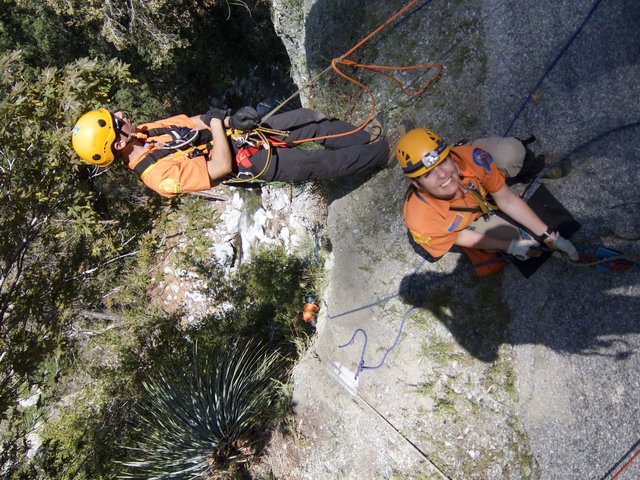 Search and Rescue Team Rappelling Down Rocky Cliff