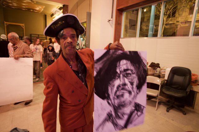 Suit-clad Rustee Allen Holds a Drawing of a Man