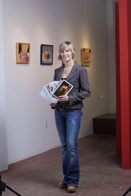 Woman in Jeans and Blazer Reading Book in Art Gallery