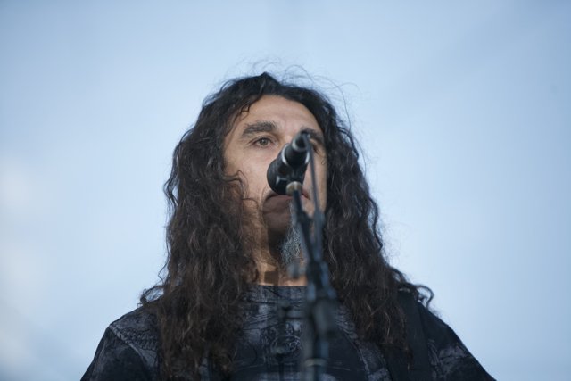 Tom Araya taking the stage with his microphone