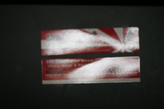 Red and White Stickers on a Black Surface