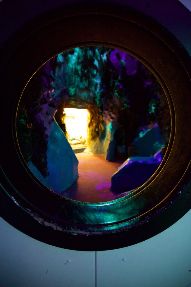 Glowing Cave Tunnel with Colorful Illuminated Formations