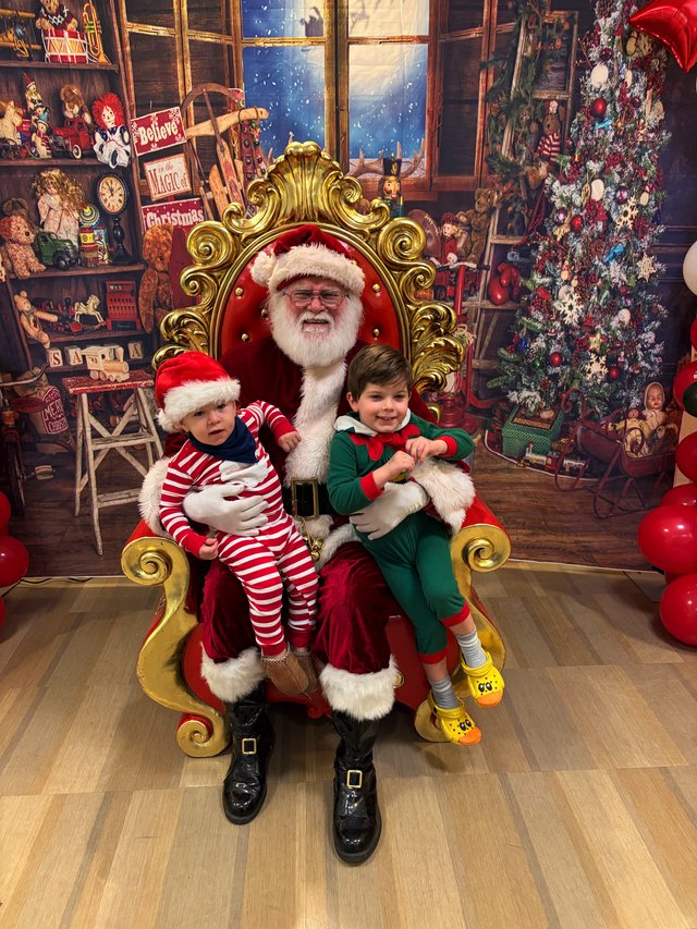 Two Children Visit Santa in His Christmas Workshop
