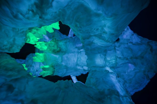 Illuminated Ice Formations in Underground Cave
