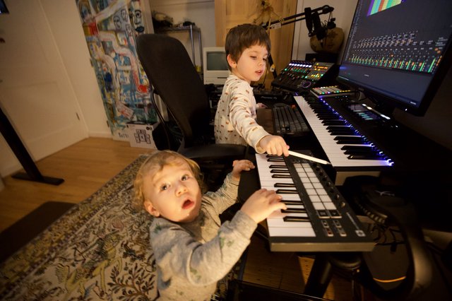 Two Young Brothers Making Music Together at Home Studio