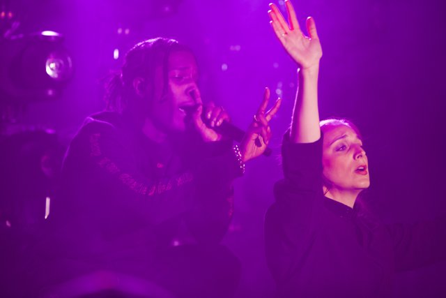 Moving the Crowd Caption: A$AP Rocky performs as Anna Bentley raises her hands in excitement during their electrifying night club concert for Coachella 2016.