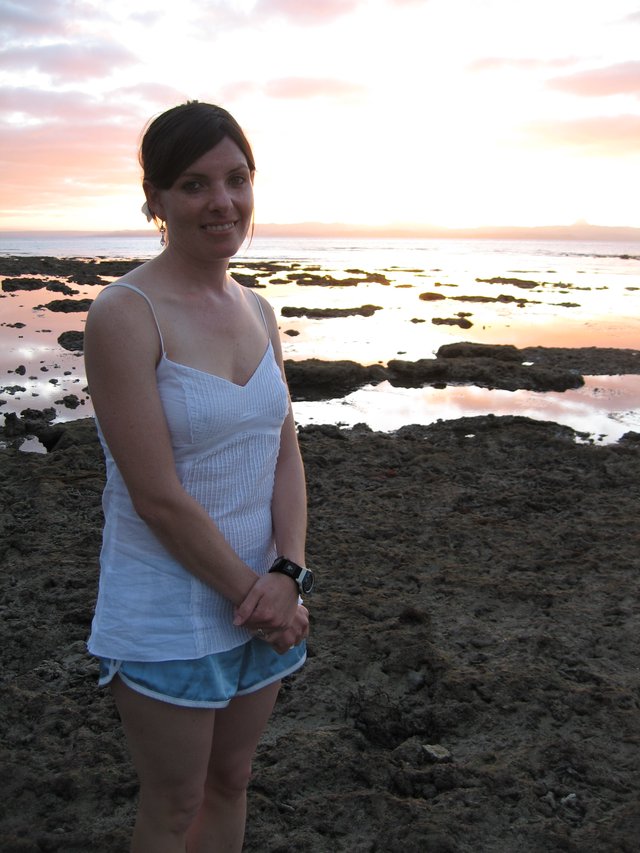 Woman Smiling at Sunset on Fiji Rocky Shore