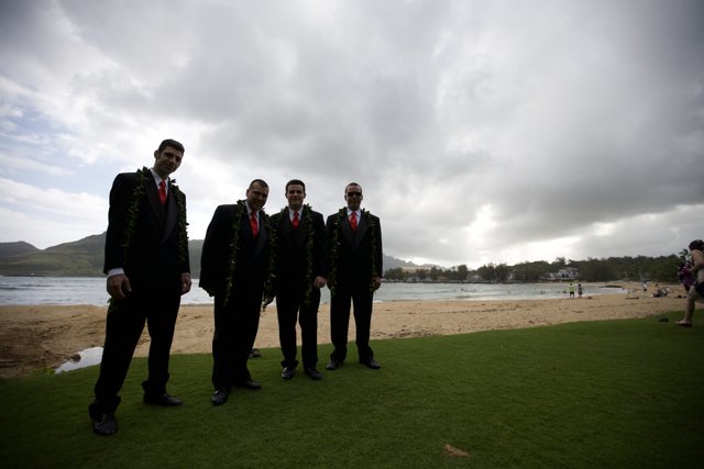 Four Men in Suits Relaxing by the Shore