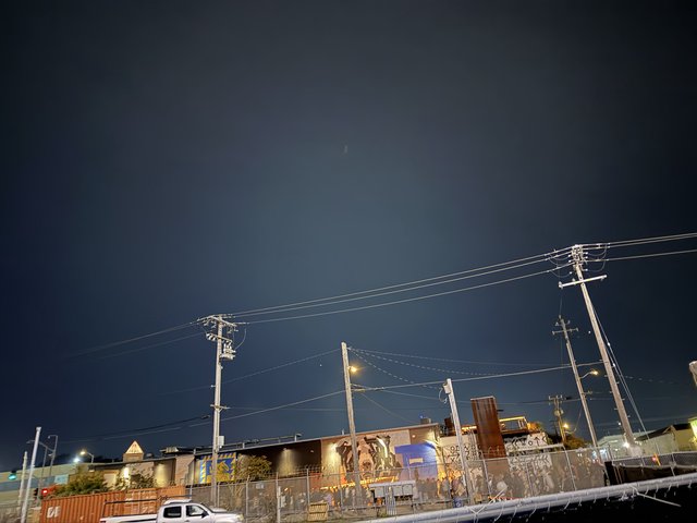 Urban Night Scene with Power Lines and Industrial Buildings