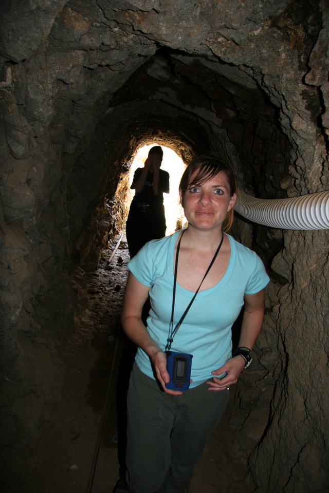 Explorer Inside Ancient Rocky Mine Tunnel Passage