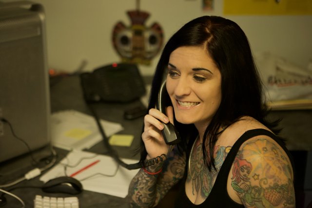 Tattooed Woman on Phone