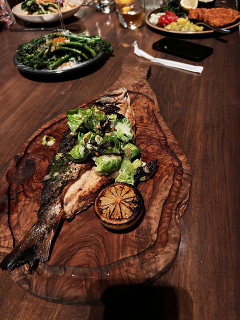 Sea Bass and Veggies on Wooden Table