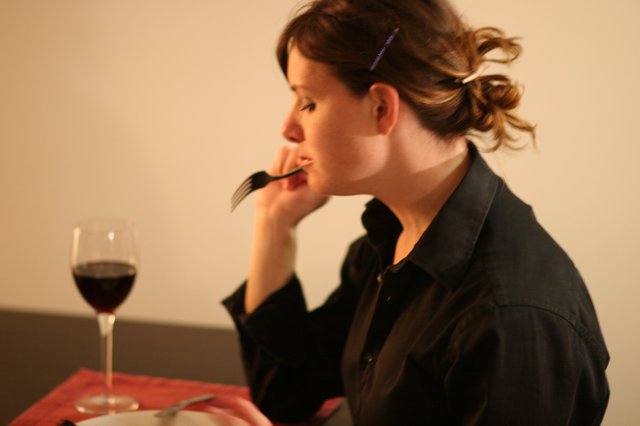 Contemplative Woman Dining Alone with Red Wine