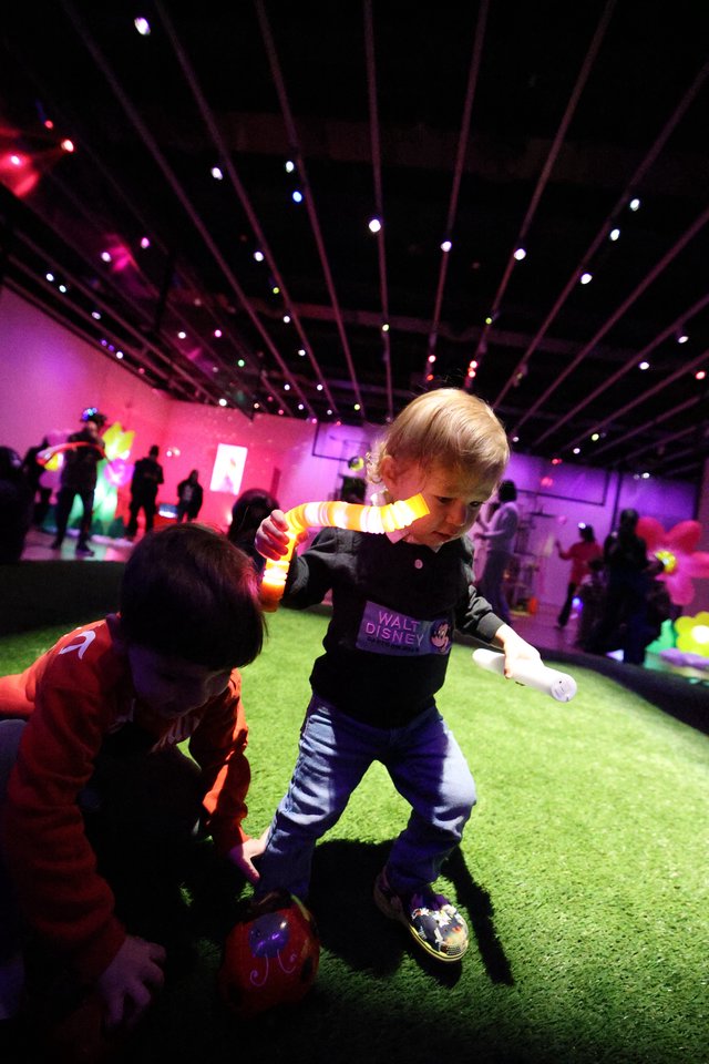 Children Playing at Baby Rave Event with Colorful Lighting