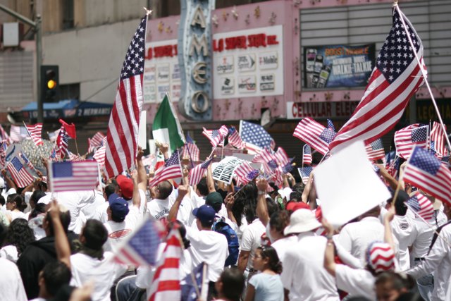 Patriotic Crowd Waves American Flags