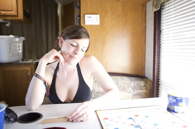 Woman Contemplates Her Scrabble Move in RV