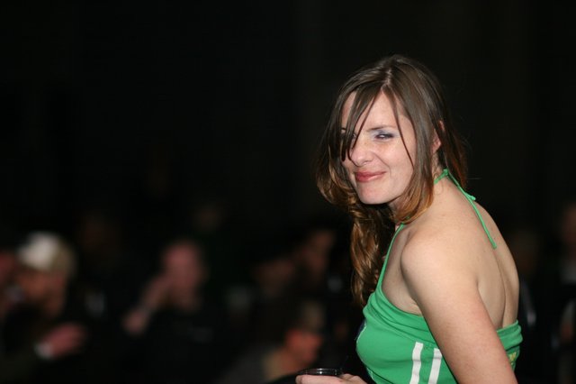Woman in Green Halter Top at Evening Event