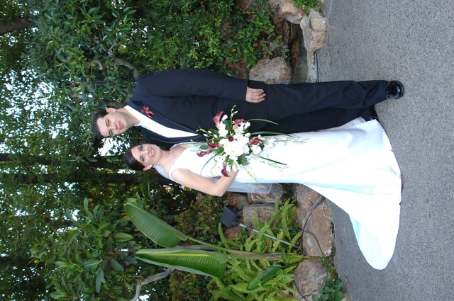 Bride and Groom Pose in Lush Garden Setting