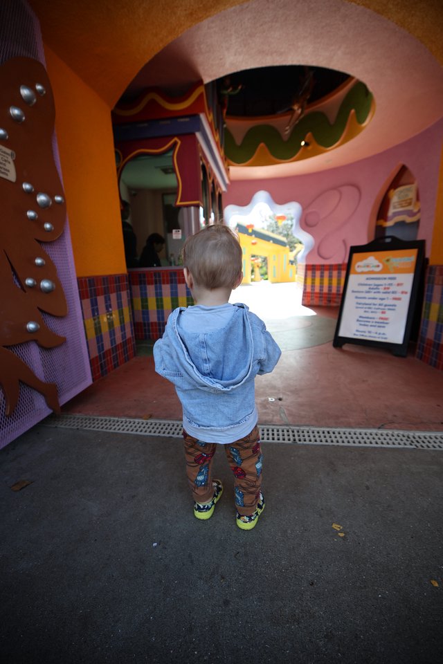 Young Child Explores Colorful Fantasyland Play Area