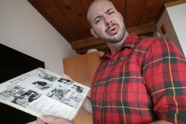 Man Reading Newspaper in Rustic Interior