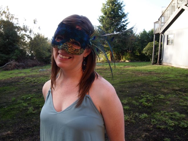Smiling Woman in Peacock Feather Masquerade Mask