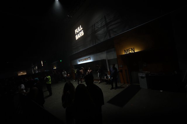 Neon Signs Glow at Wobbleland Festival Concourse