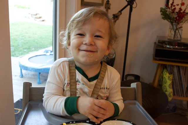 Toddler's Joyful Mealtime During Christmas Season