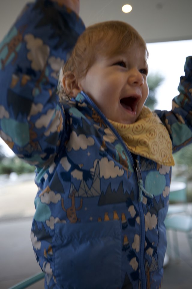 Joyful Toddler in Cloud-Pattern Winter Jacket