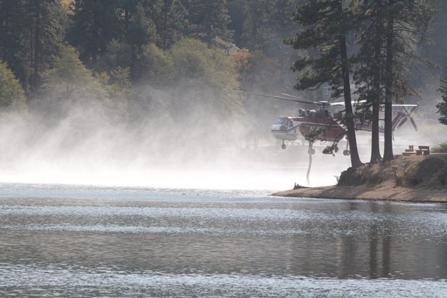 Helicopter Spraying Water on Lake during 2007 Fire