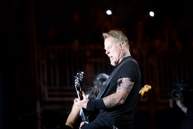 James Hetfield rocks the stage with his guitar and tattoos