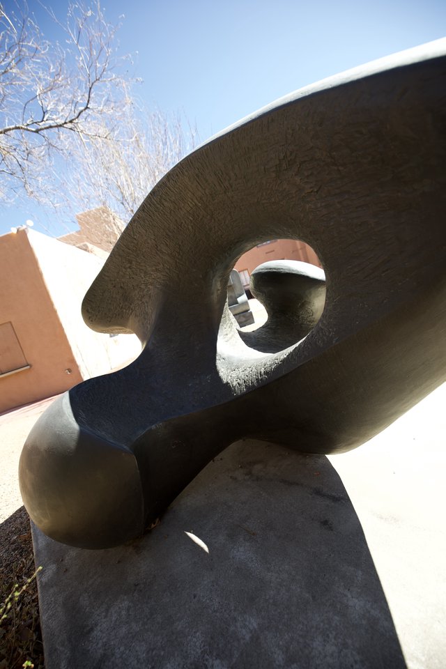 Abstract Bronze Sculpture with Circular Void in Winter Sunlight