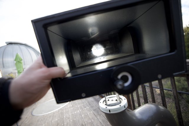 Opening the Grill Lid on an Outdoor Deck