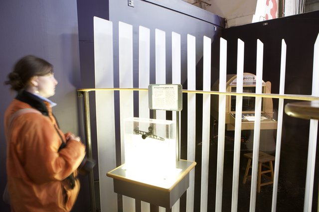 Museum Visitor Examines Disappearing Glass Rods Exhibit