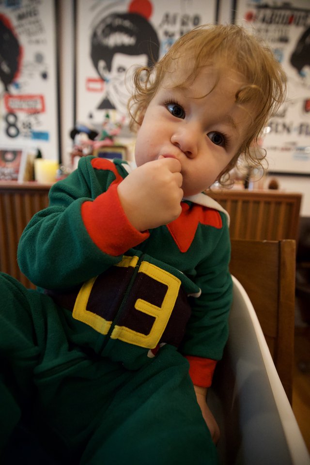 Adorable Toddler in Christmas Elf Costume at Restaurant
