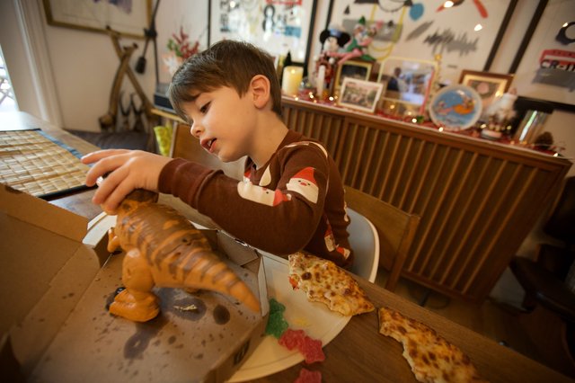 Young Boy Enjoying Pizza on Christmas Day
