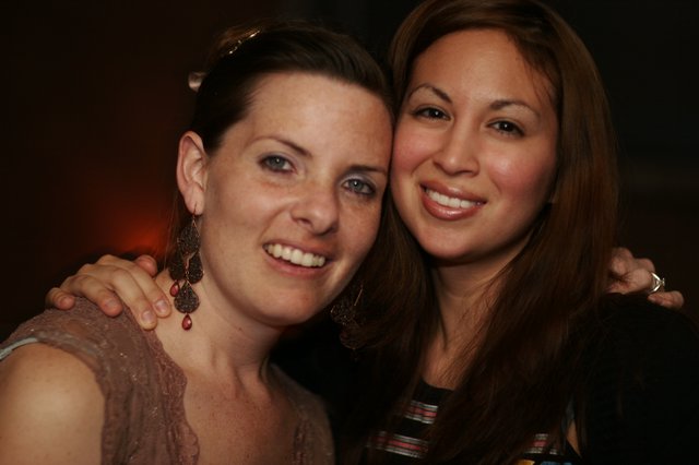 Two Friends Smiling at a Nightclub Celebration