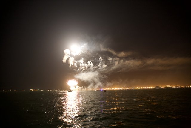 Fireworks Illuminate the Night Sky over the Ocean