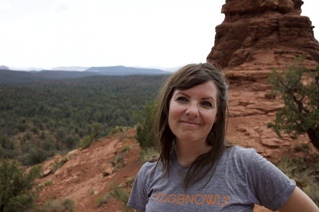 Woman Smiling Atop Red Rock Formation in Sedona