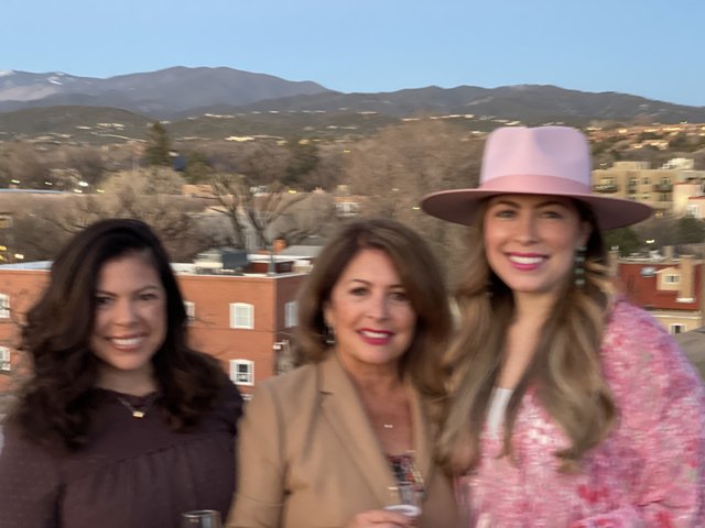 Women in Hats with a Mountainous Backdrop
