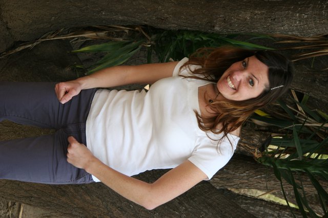 Smiling Woman Posing Between Tropical Trees