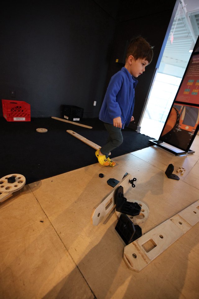 Child Exploring Interactive Science Museum Exhibit