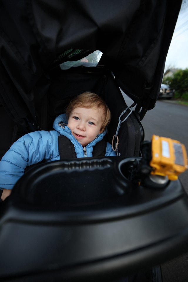 Curious Toddler Exploring Baby Stroller Controls