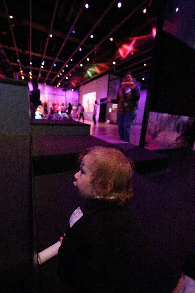 Child Mesmerized by Colorful Baby Rave Light Display