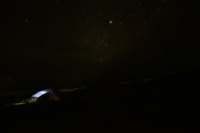 Mountain tent under the starry night sky