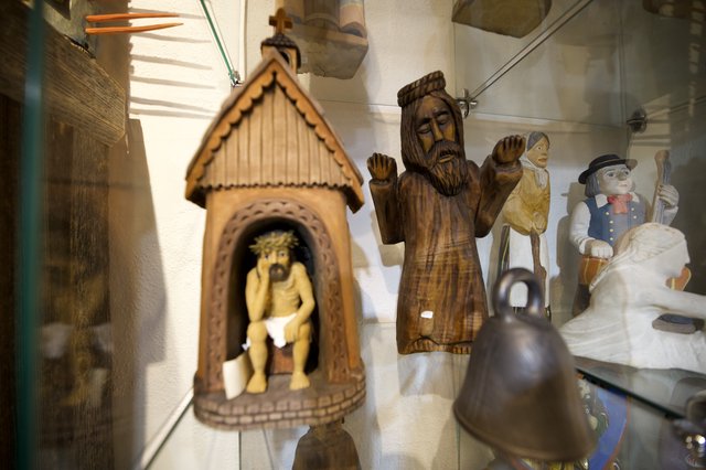 Collection of Folk Art and Religious Wood Carvings Display