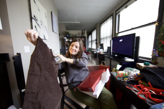 Joyful Christmas Gift Unwrapping in Modern Apartment