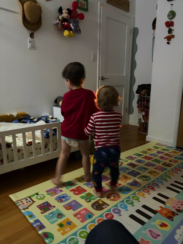 Two Young Children Playing in Colorful Bedroom