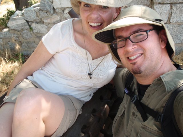 Two Smiling Travelers Posing at Ancient Ruins
