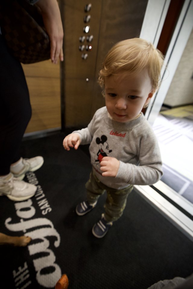 Young Child in Mickey Mouse Shirt in Hotel Elevator